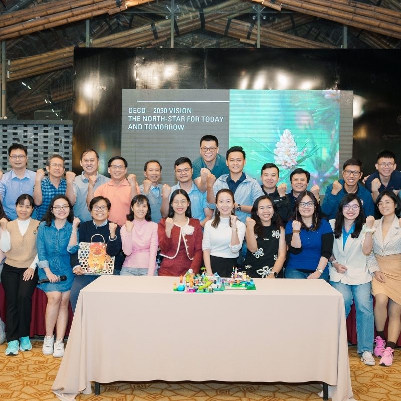 Conference group photo in front of a branded stage